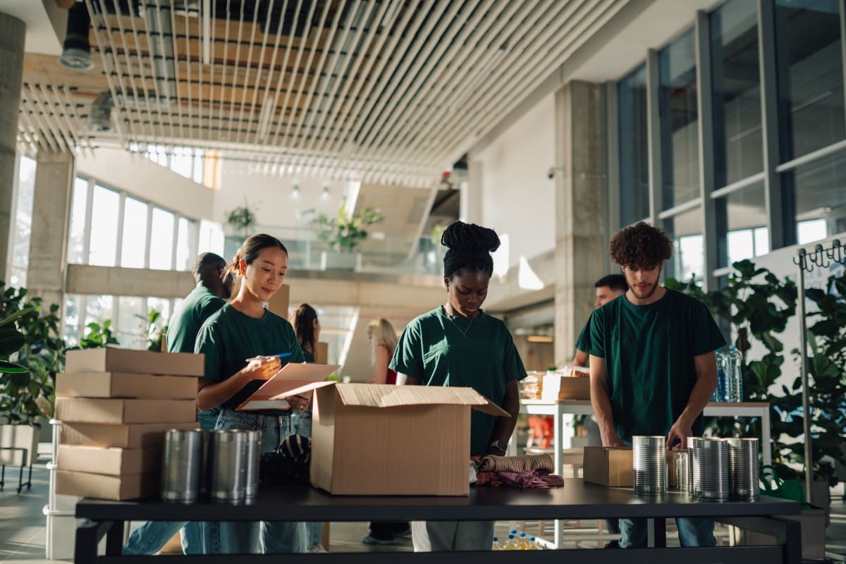 Volunteers packing boxes in a community center.