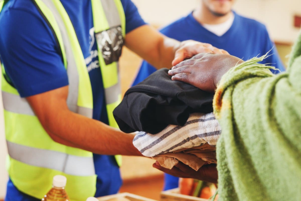 Volunteers distributing clothes at donation center.